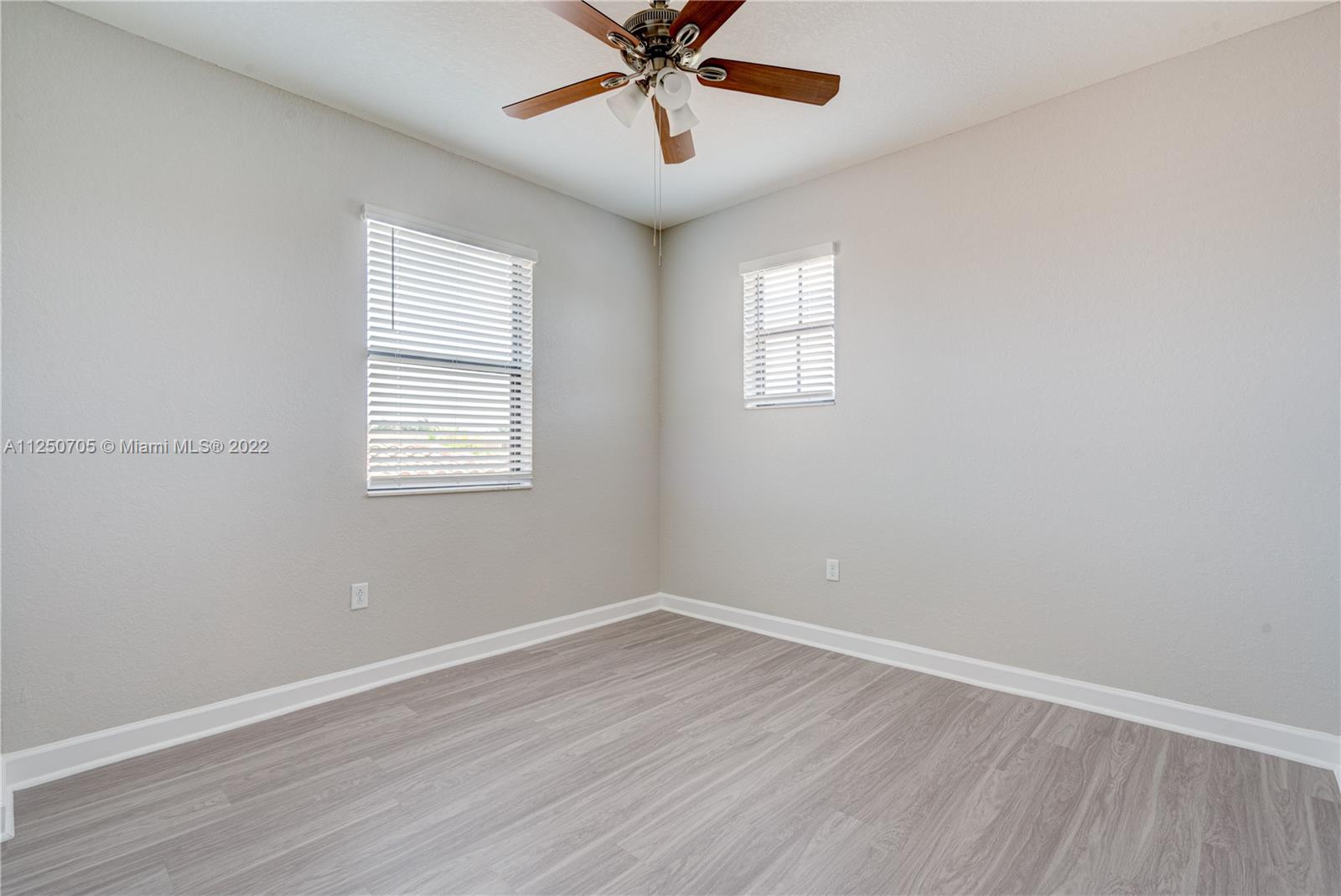 124 Northeast 25th Avenue Homestead, FL 33033 - Photo 15 of 32 wooden floor in an empty room with a window