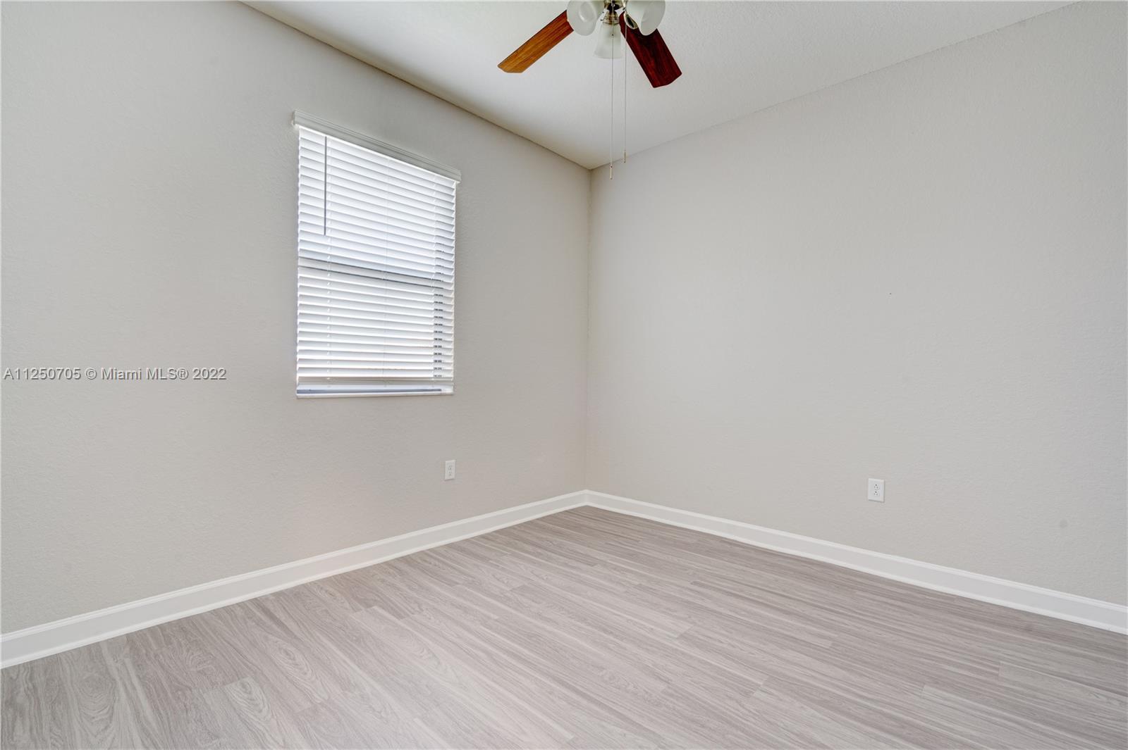 124 Northeast 25th Avenue Homestead, FL 33033 - Photo 21 of 32 an empty room with a window and ceiling fan