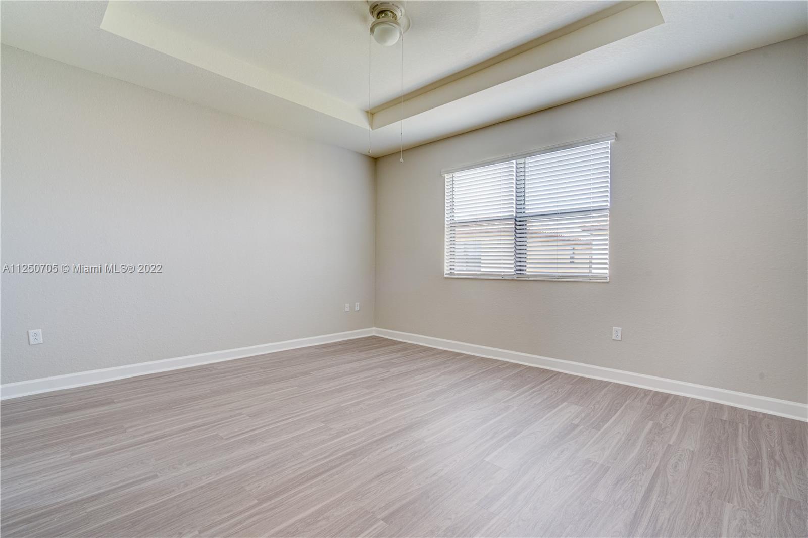 124 Northeast 25th Avenue Homestead, FL 33033 - Photo 23 of 32 an empty room with wooden floor and windows