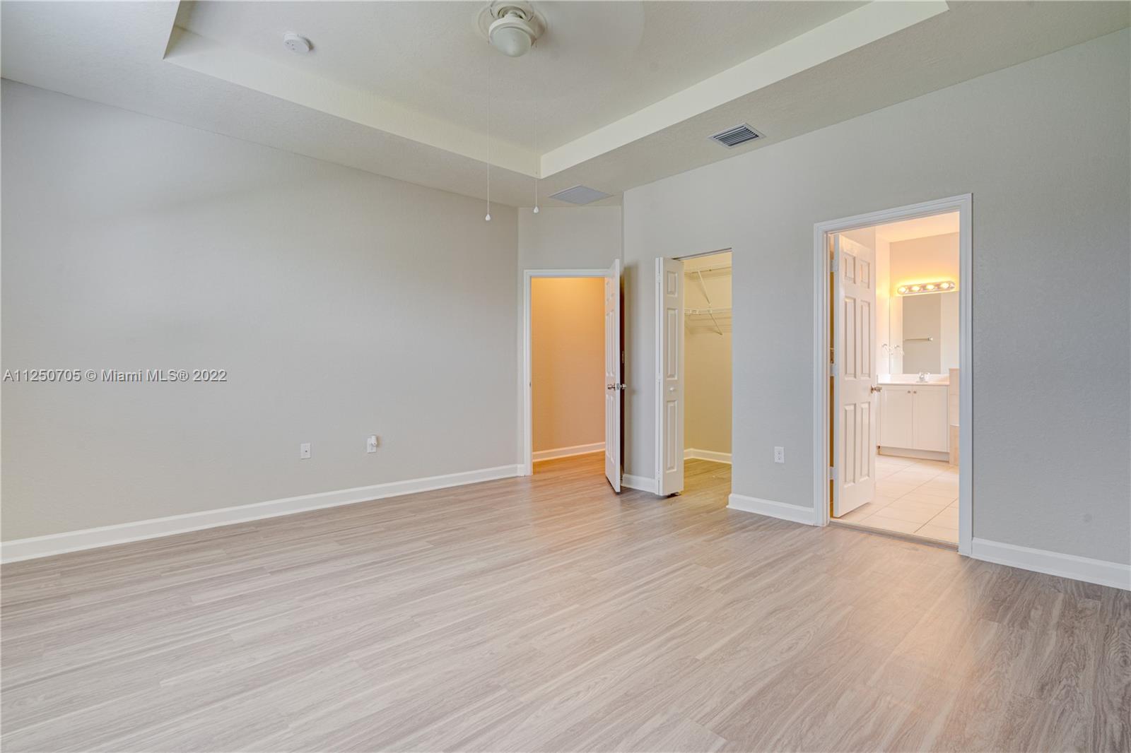 124 Northeast 25th Avenue Homestead, FL 33033 - Photo 25 of 32 an empty room with wooden floor and closet