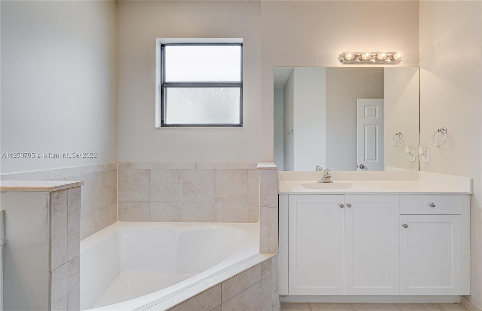 124 Northeast 25th Avenue Homestead, FL 33033 - Photo 28 of 32 a bathroom with a bathtub and a sink