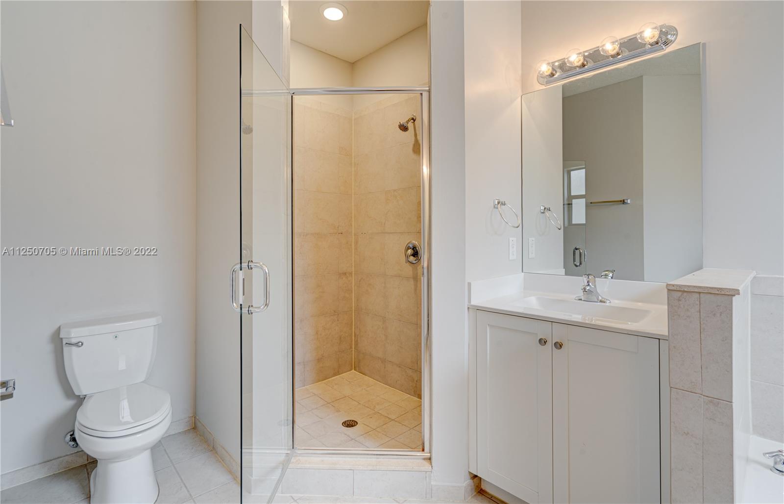 124 Northeast 25th Avenue Homestead, FL 33033 - Photo 29 of 32 a bathroom with a shower sink vanity and toilet