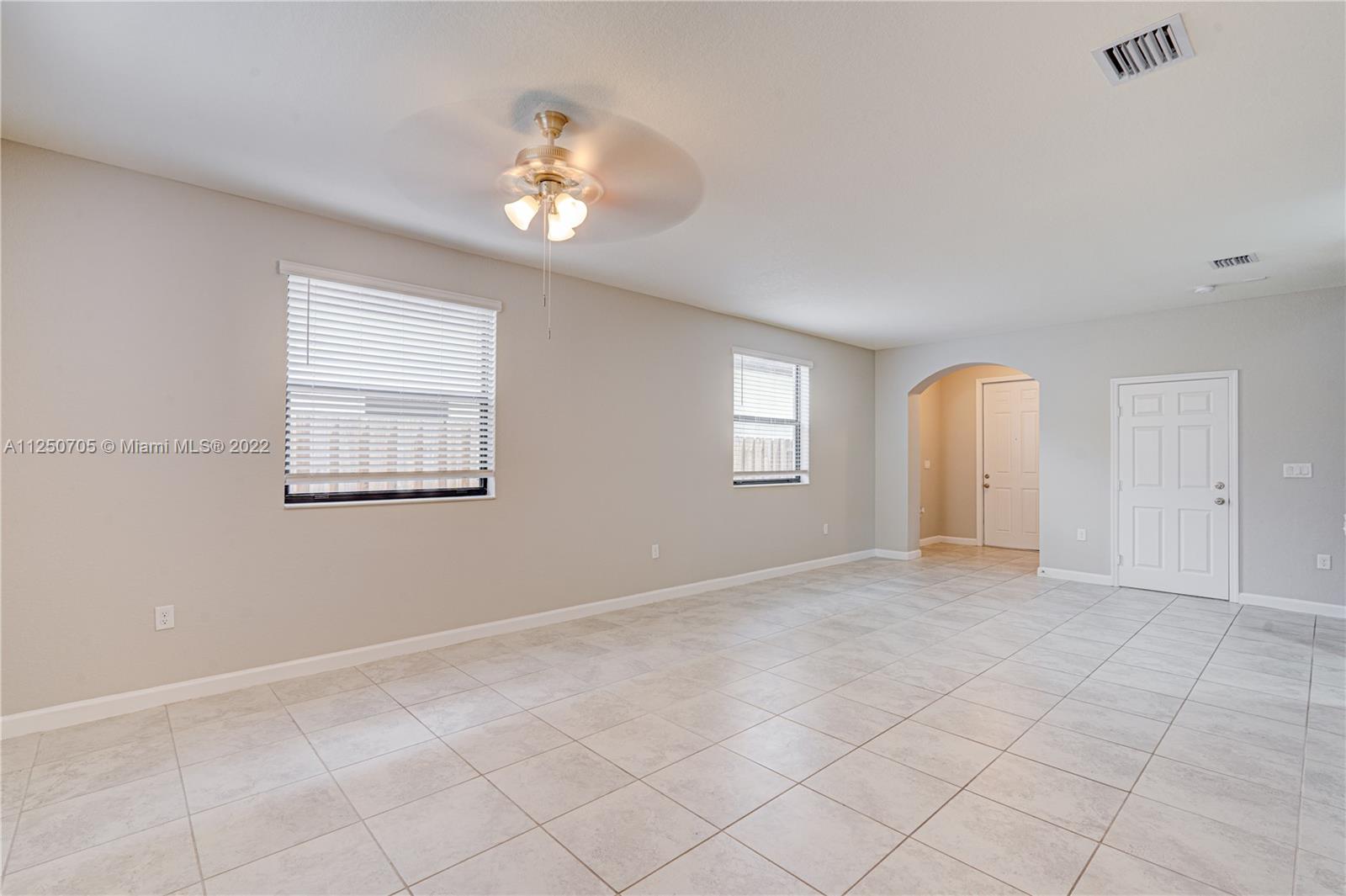 124 Northeast 25th Avenue Homestead, FL 33033 - Photo 6 of 32 a view of an empty room with a window