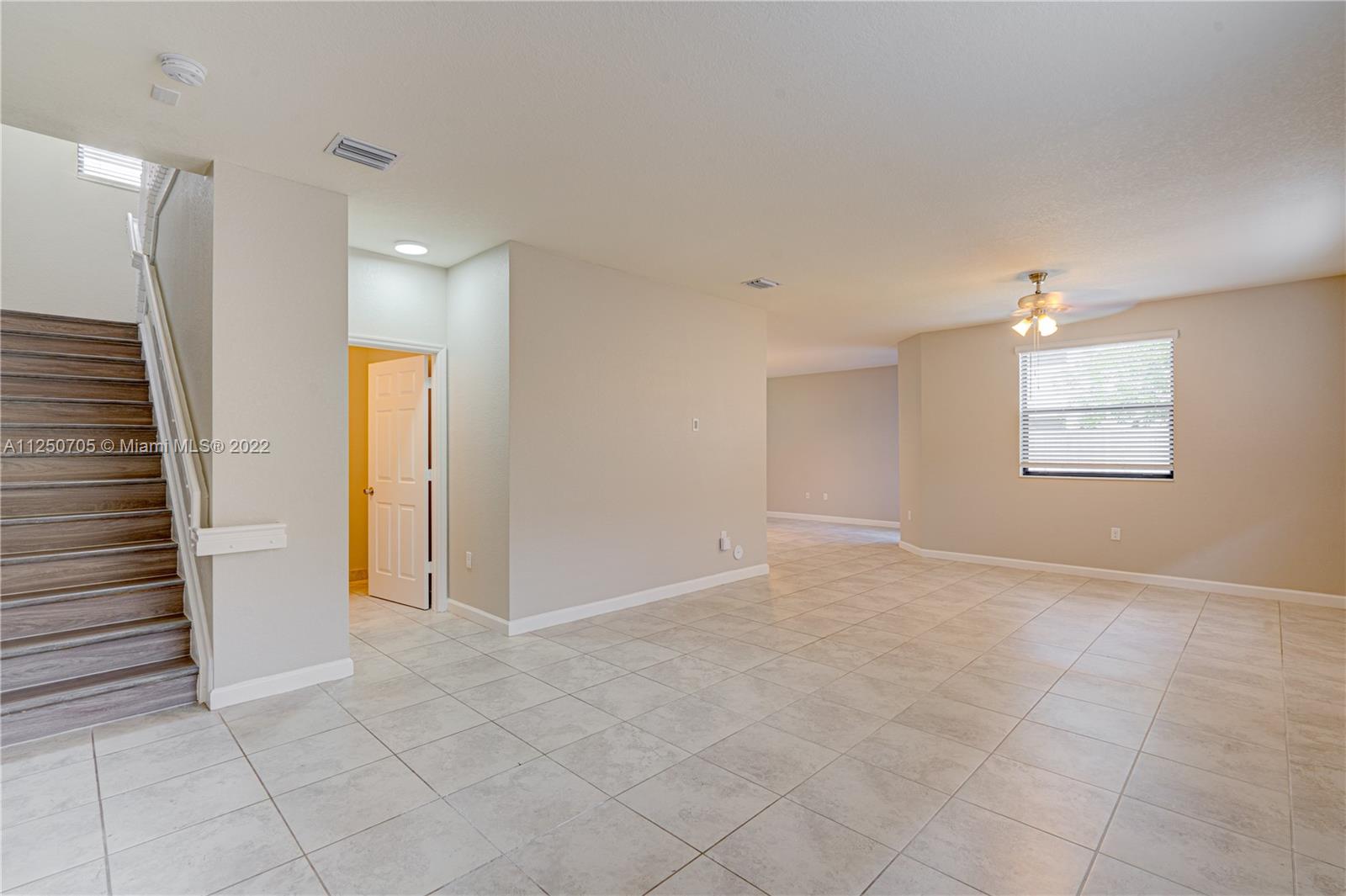 124 Northeast 25th Avenue Homestead, FL 33033 - Photo 9 of 32 an empty room with windows and closet