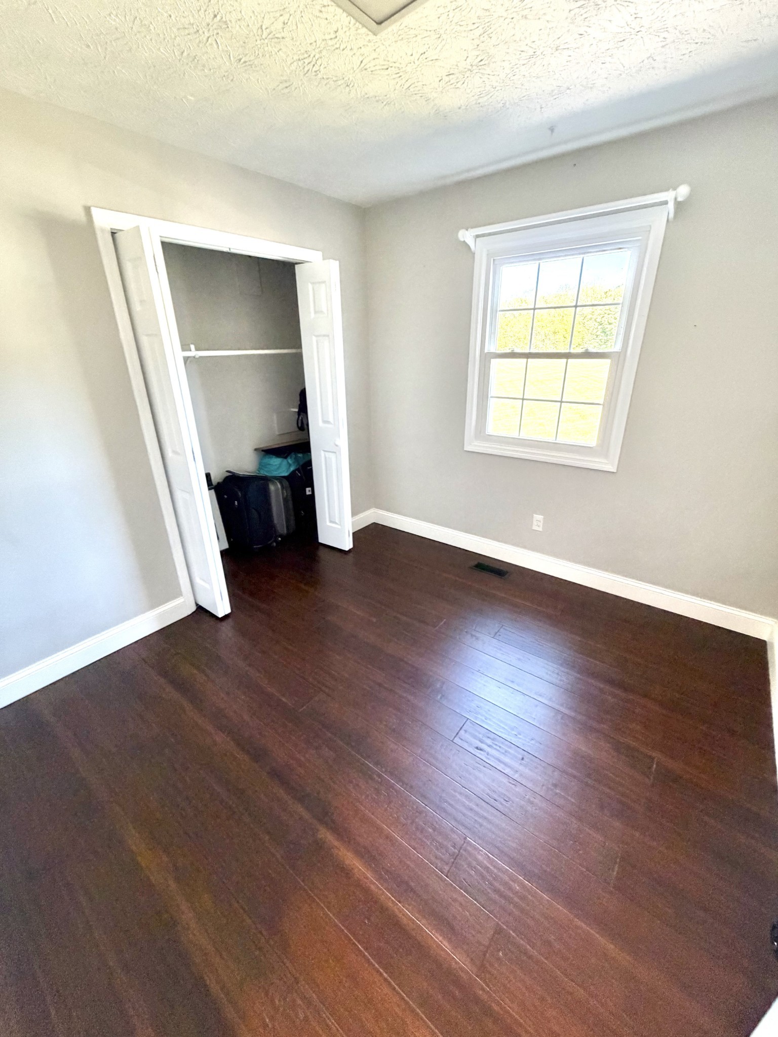 356 Lee Road Cottontown, TN 37048 - Photo 17 of 52 an empty room with wooden floor closet and windows