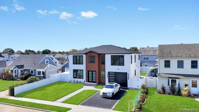 a view of a big house with a big yard and large trees