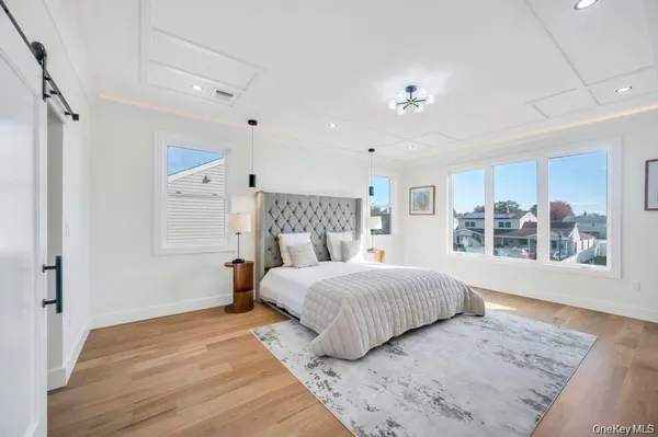 a bedroom with a large bed and a window