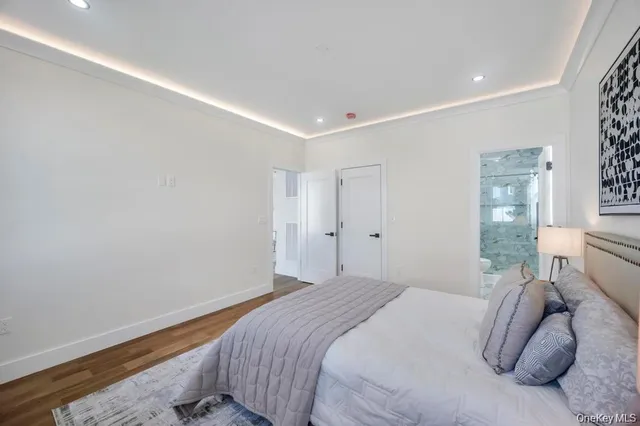 a bedroom with a bed and a night stand