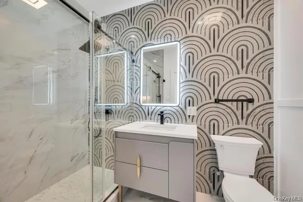 a bathroom with a mirror and a sink
