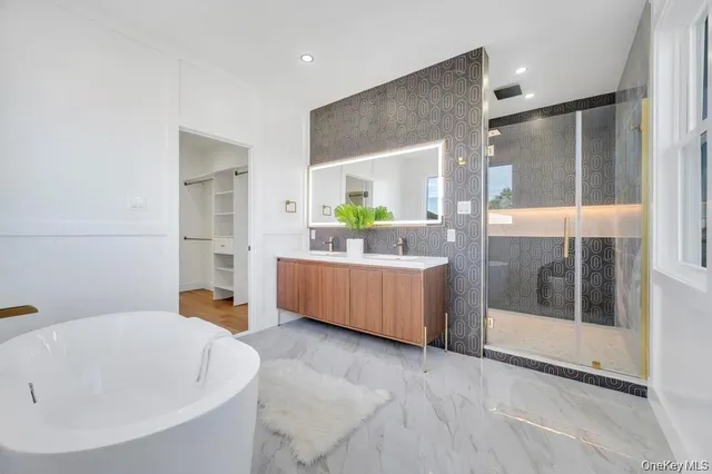 a bathroom with a tub sink and mirror