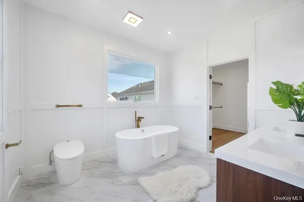 a bathroom with a sink toilet and a mirror