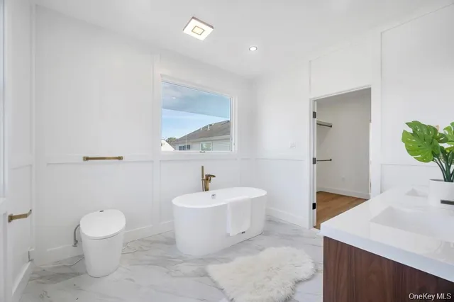 a bathroom with a sink toilet and a mirror