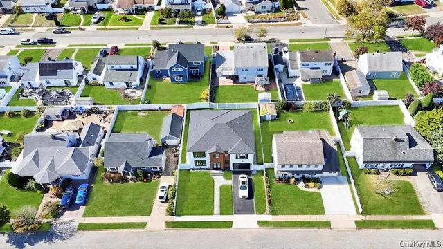 an aerial view of houses with outdoor space and parking