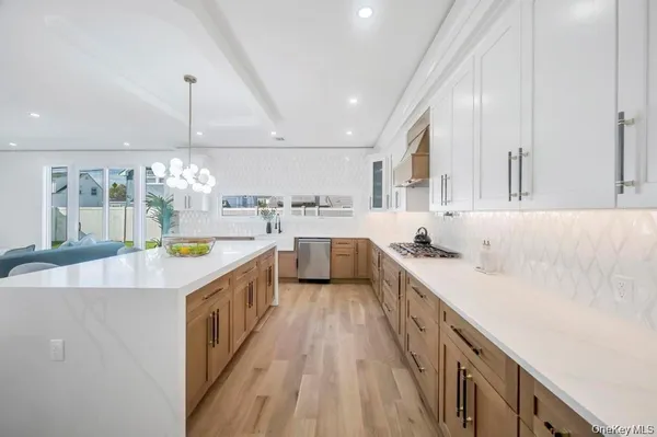 a large kitchen with stainless steel appliances lots of counter top space