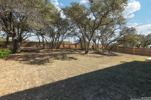 a view of snow on the side of road and trees