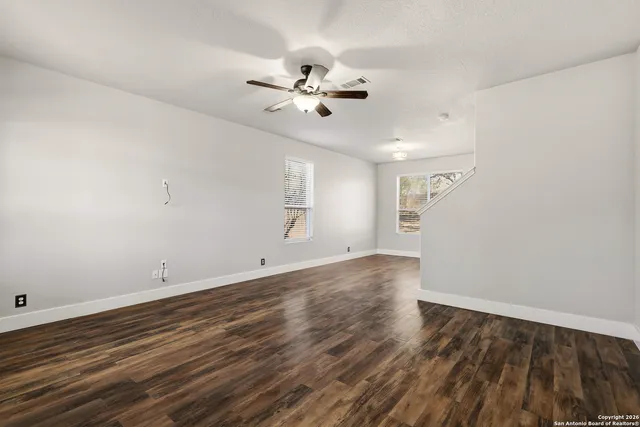 wooden floor in an empty room with a window