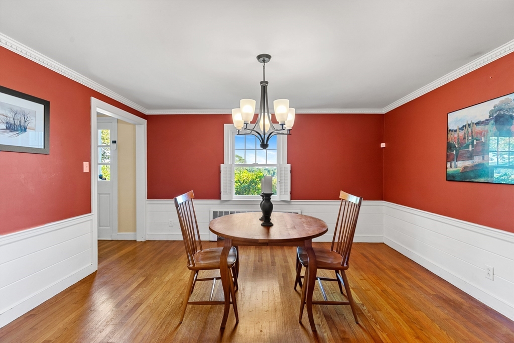 58 Hutchinson Road Arlington, MA 02474 - Photo 12 of 40 a dining room with furniture a chandelier and wooden floor