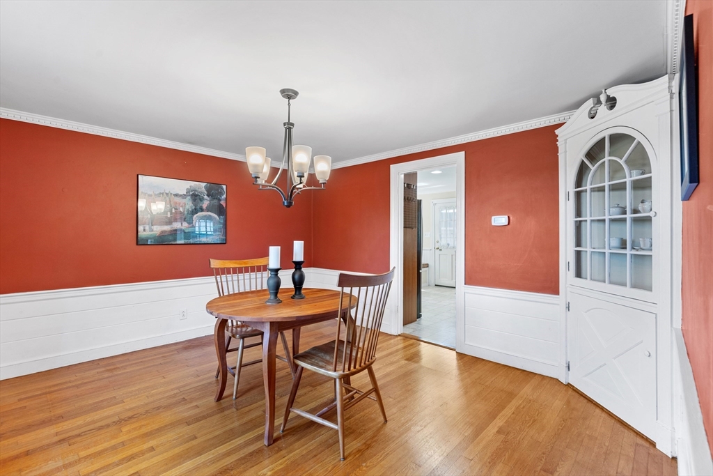 58 Hutchinson Road Arlington, MA 02474 - Photo 13 of 40 a view of a dining room with furniture a chandelier and wooden floor