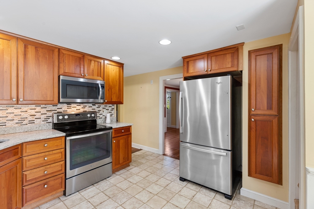 58 Hutchinson Road Arlington, MA 02474 - Photo 14 of 40 a kitchen with granite countertop a refrigerator stove and microwave