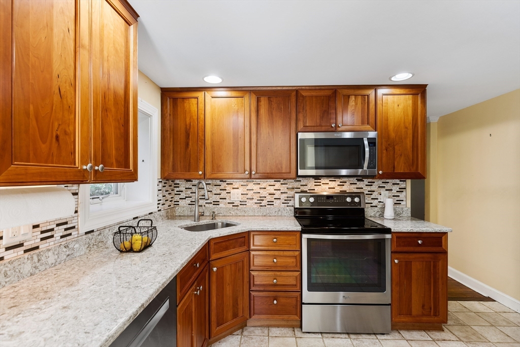 58 Hutchinson Road Arlington, MA 02474 - Photo 15 of 40 a kitchen with stainless steel appliances a stove a sink and a microwave