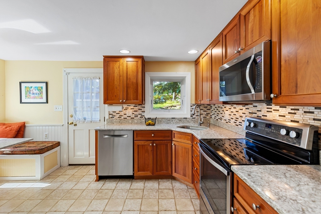 58 Hutchinson Road Arlington, MA 02474 - Photo 16 of 40 a kitchen with stainless steel appliances a stove sink and cabinets