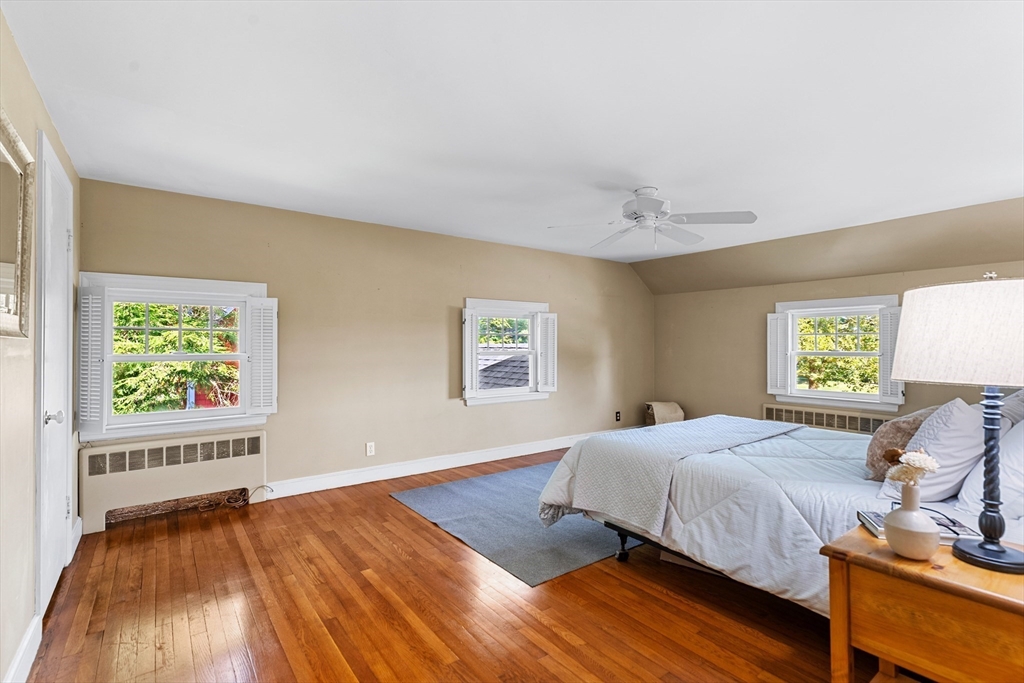 58 Hutchinson Road Arlington, MA 02474 - Photo 21 of 40 a bedroom with a bed and a window with chair