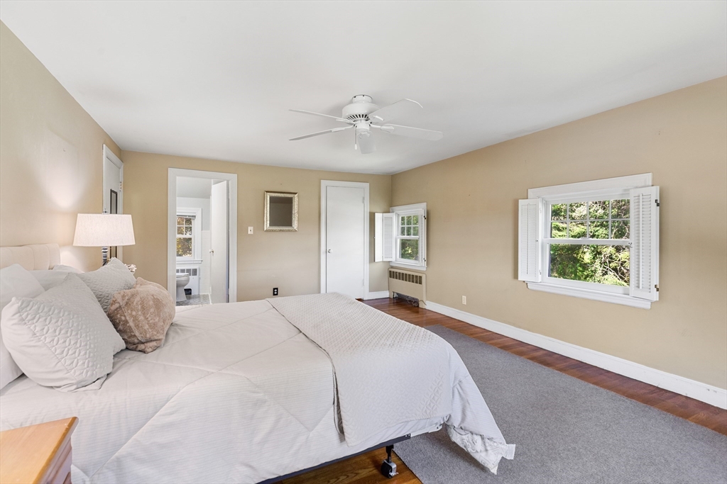 58 Hutchinson Road Arlington, MA 02474 - Photo 22 of 40 a bedroom with a large bed and a chandelier