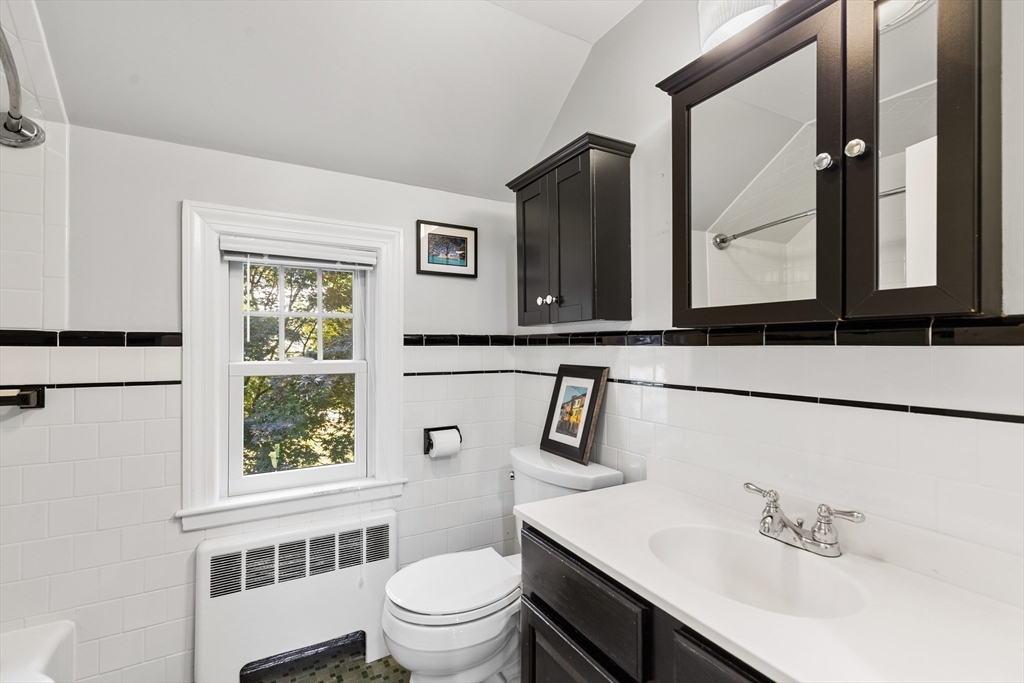 58 Hutchinson Road Arlington, MA 02474 - Photo 26 of 40 a bathroom with a sink a toilet and a window