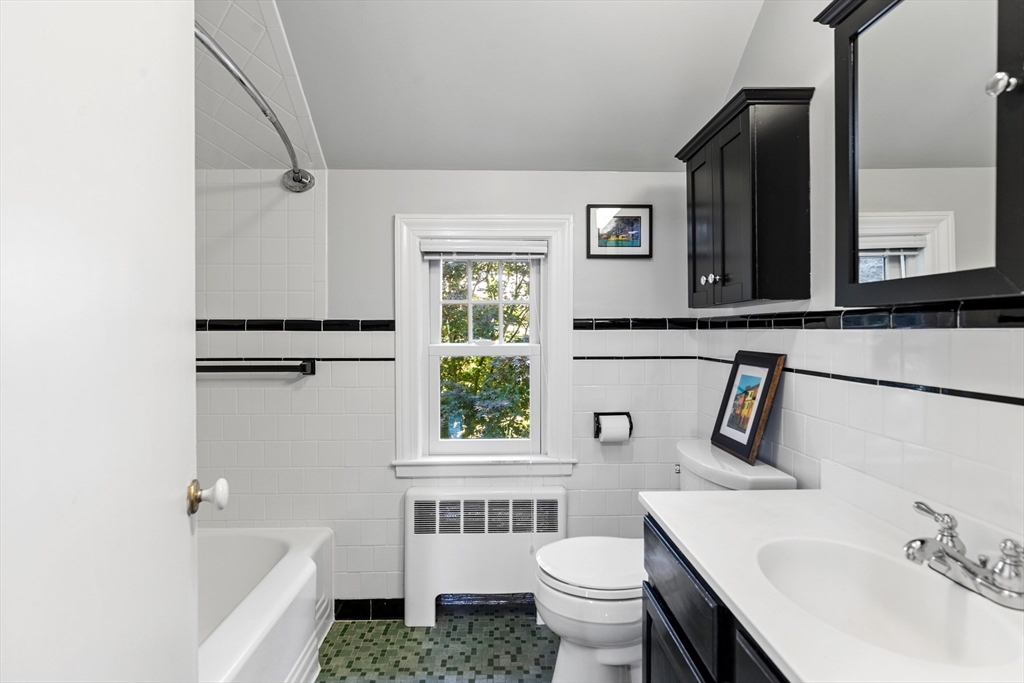 58 Hutchinson Road Arlington, MA 02474 - Photo 27 of 40 a bathroom with a sink toilet a mirror and bathtub