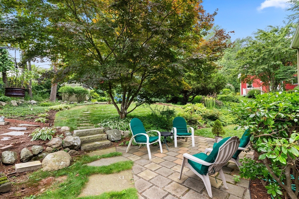 58 Hutchinson Road Arlington, MA 02474 - Photo 36 of 40 a backyard of a house with table and chairs