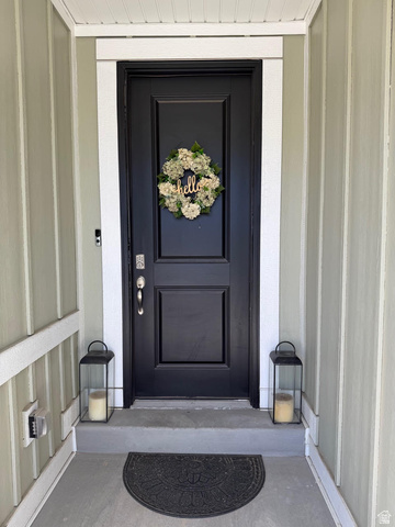 315 South Sherman Street Mapleton, UT 84664 - Photo 4 of 30 Front entry featuring a paneled door with polished hardware, contrasting trim, and vertical siding