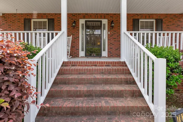 a porch with a bench next to a yard