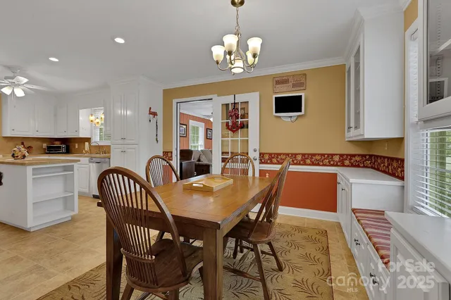 a view of a dining room with furniture and chandelier