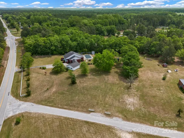an aerial view of a house with yard swimming pool and outdoor seating