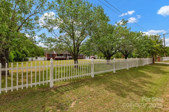 a view of house with outdoor space and swimming pool