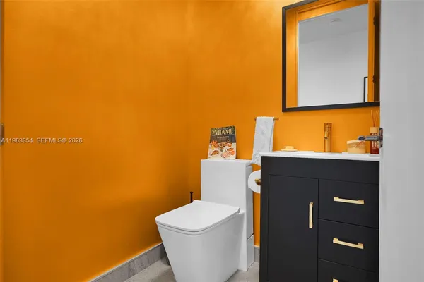 a white toilet sitting next to a bathroom sink