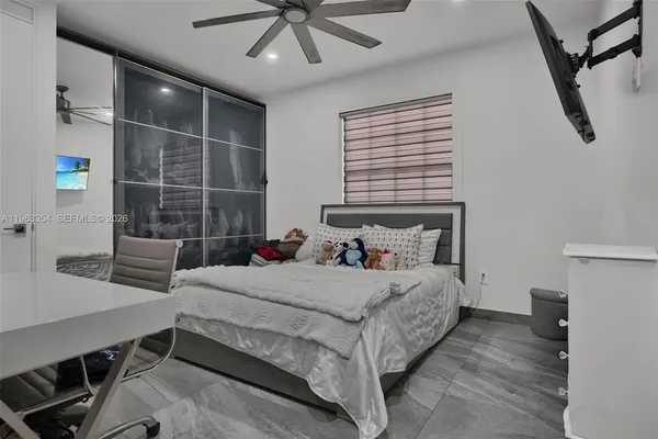 a bedroom with a bed and a desk