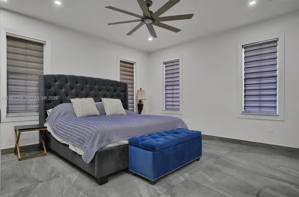 a bedroom with a bed rug and window