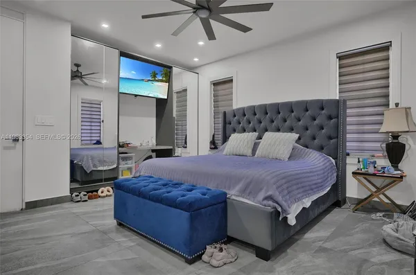 a bedroom with a bed and a chandelier