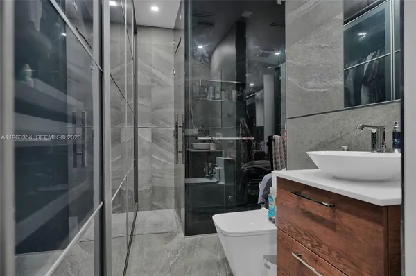 a bathroom with a sink a toilet and shower