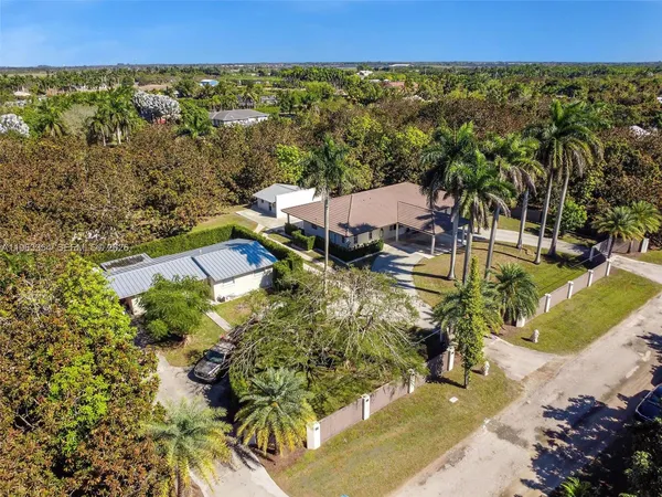 an aerial view of a house with a yard