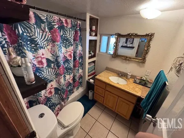 a bathroom with a sink mirror vanity and toilet