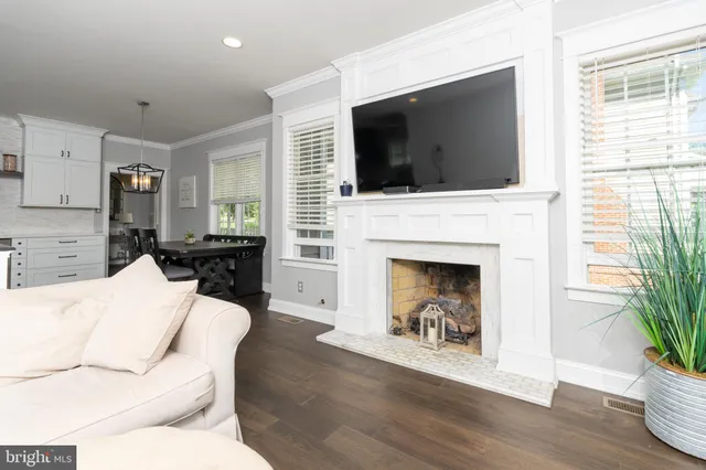 a living room with a fireplace and a flat screen tv