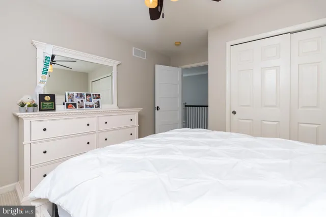 a spacious bedroom with a bed and cabinets