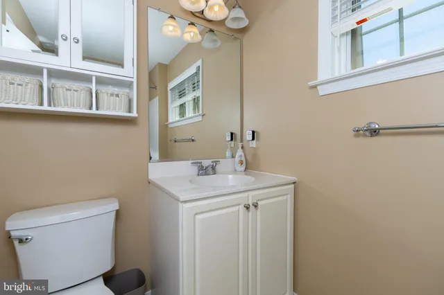 a bathroom with a sink a toilet and a mirror