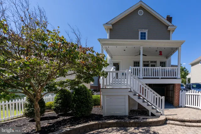 a view of house with swimming pool and wooden fence