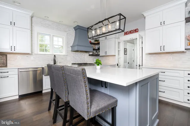 a kitchen with a table chairs sink and cabinets