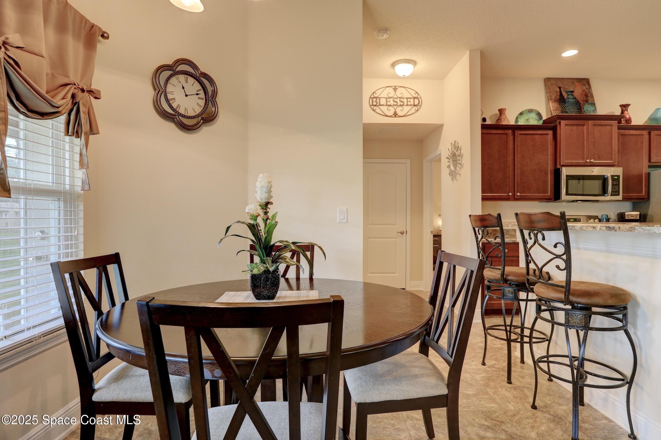 443 Lanfair Avenue Sebastian, FL 32958 - Photo 11 of 33 a view of a dining room with furniture and a chandelier