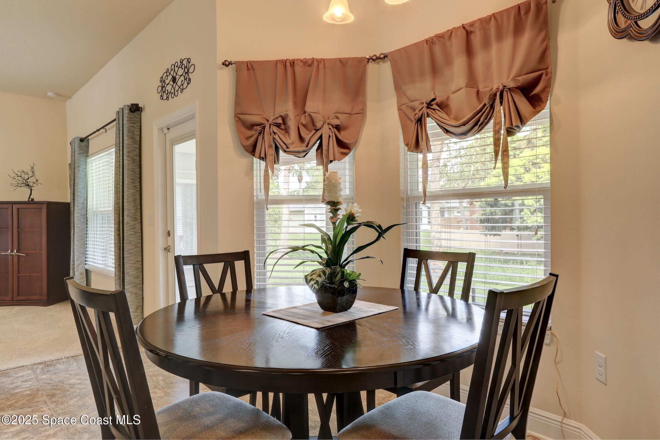 443 Lanfair Avenue Sebastian, FL 32958 - Photo 12 of 33 a view of a dining room with furniture window and wooden floor