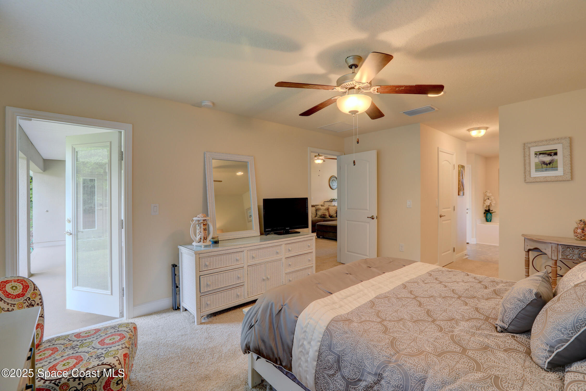 443 Lanfair Avenue Sebastian, FL 32958 - Photo 14 of 33 a bedroom with a bed and a chandelier